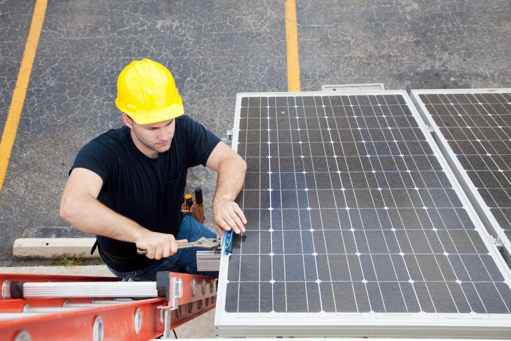 man installing solar panel