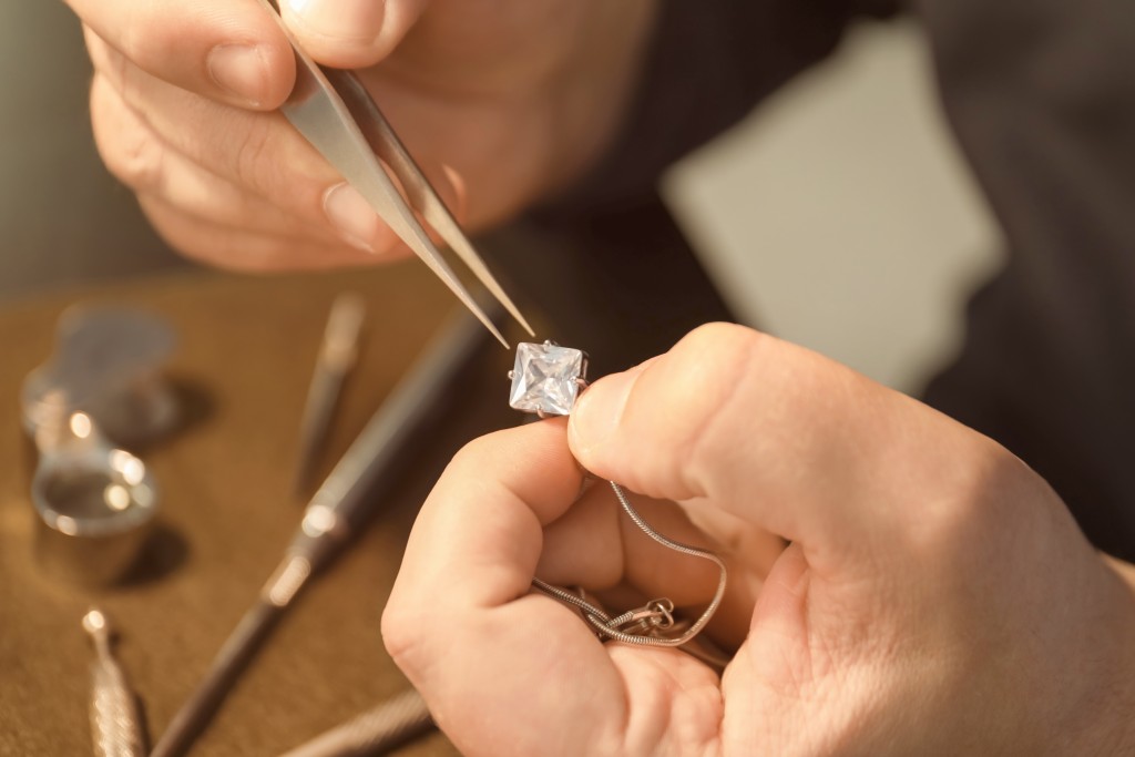 a man customizing a diamond necklace