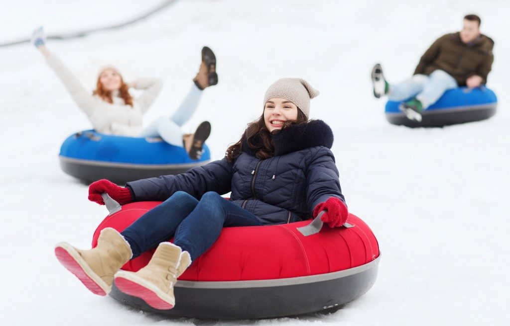 family sliding on snow