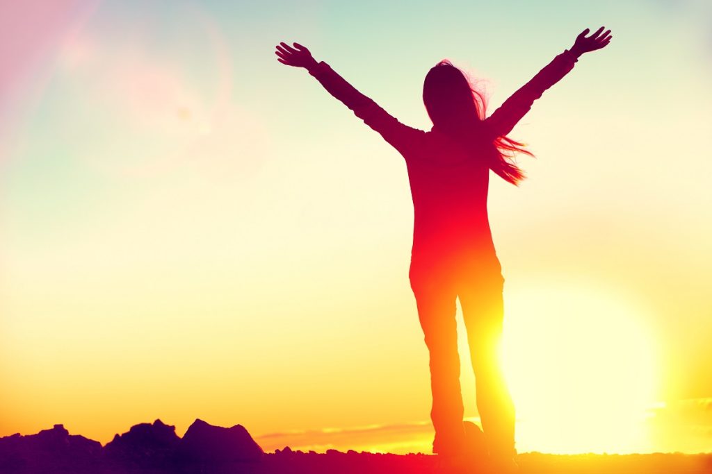 Woman standing on top of a mountain