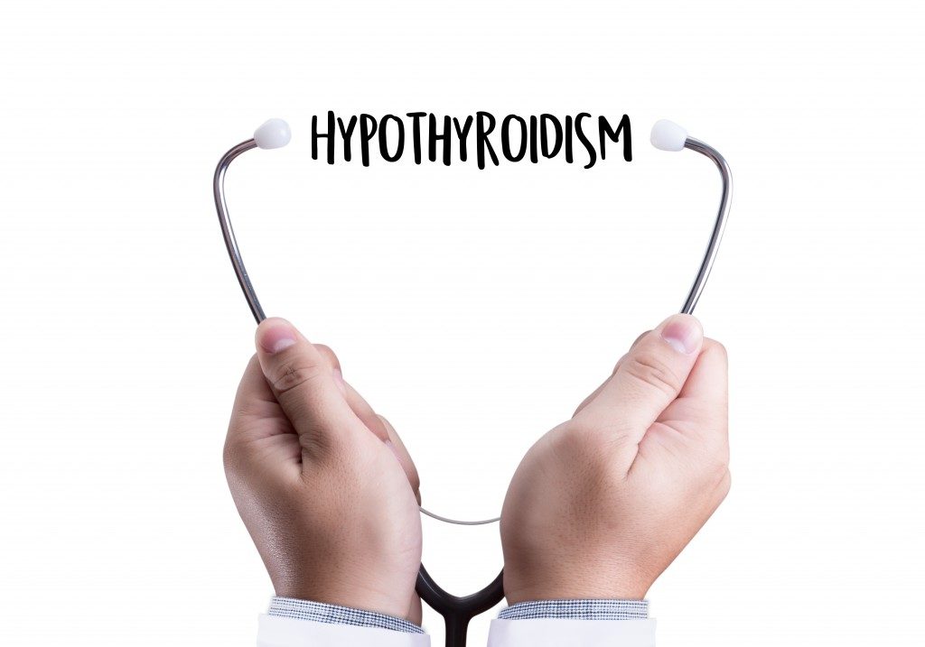 Doctor holding stethoscope with hypothyroidism