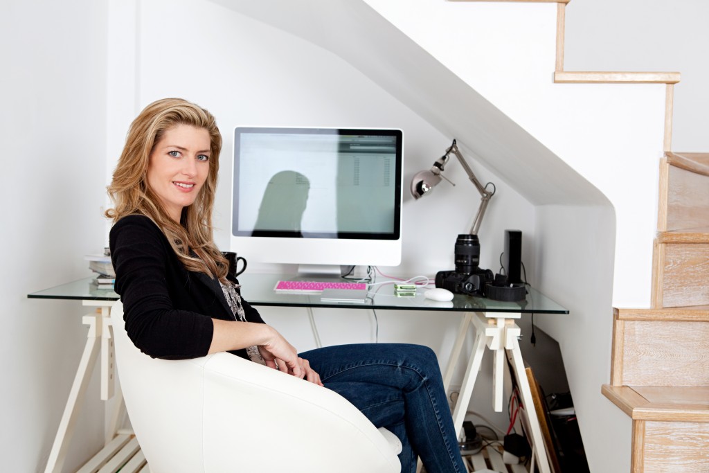 Young professional photographer working from home and sitting at her desk at home