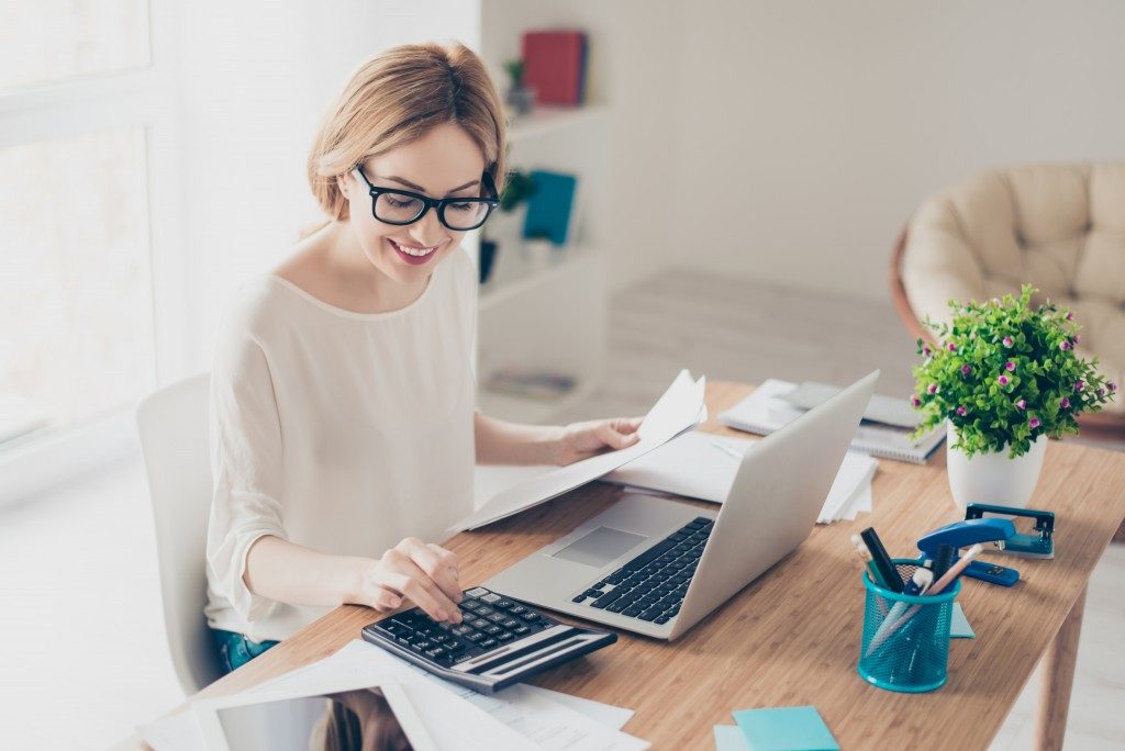 Woman computing in calculator