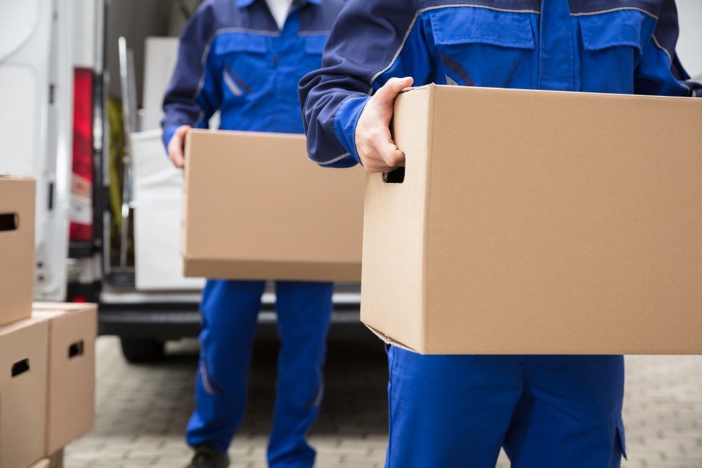 Two movers carrying boxes