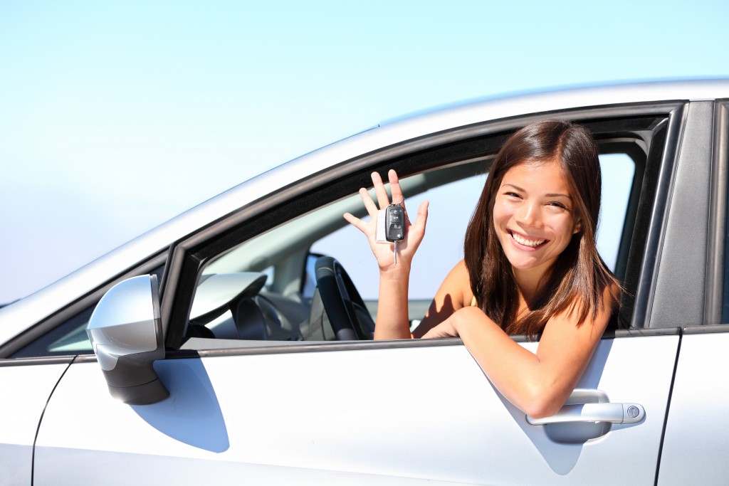 woman holding car keys and smiling