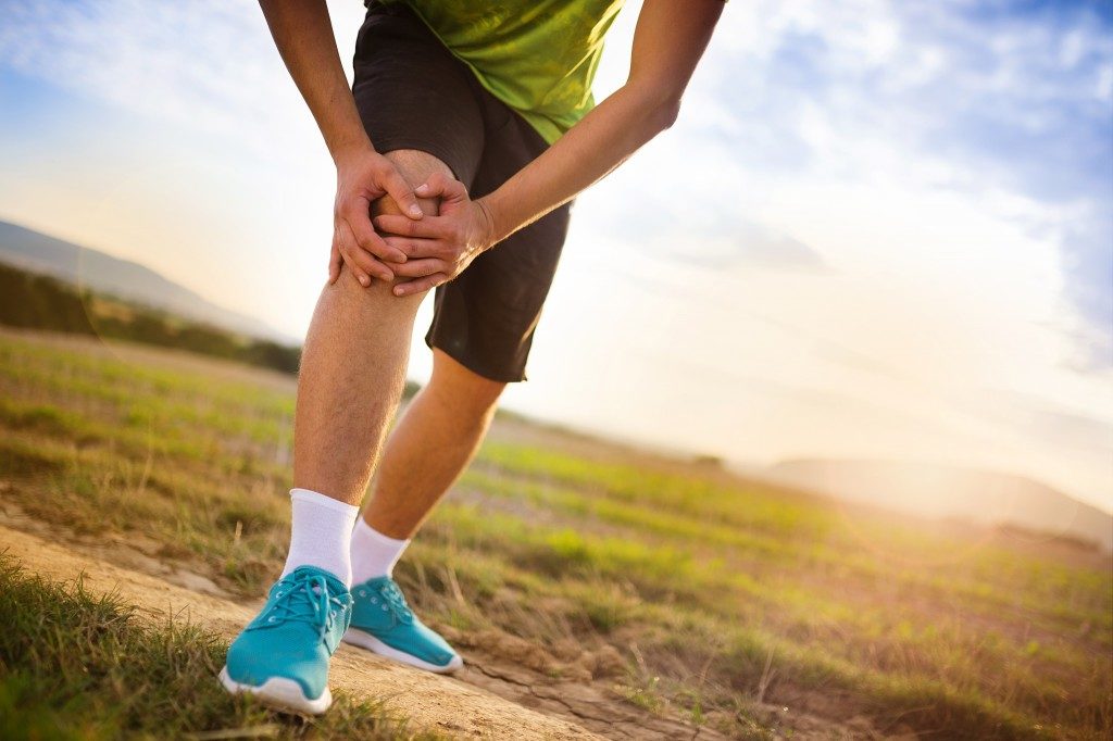 man holding his knee