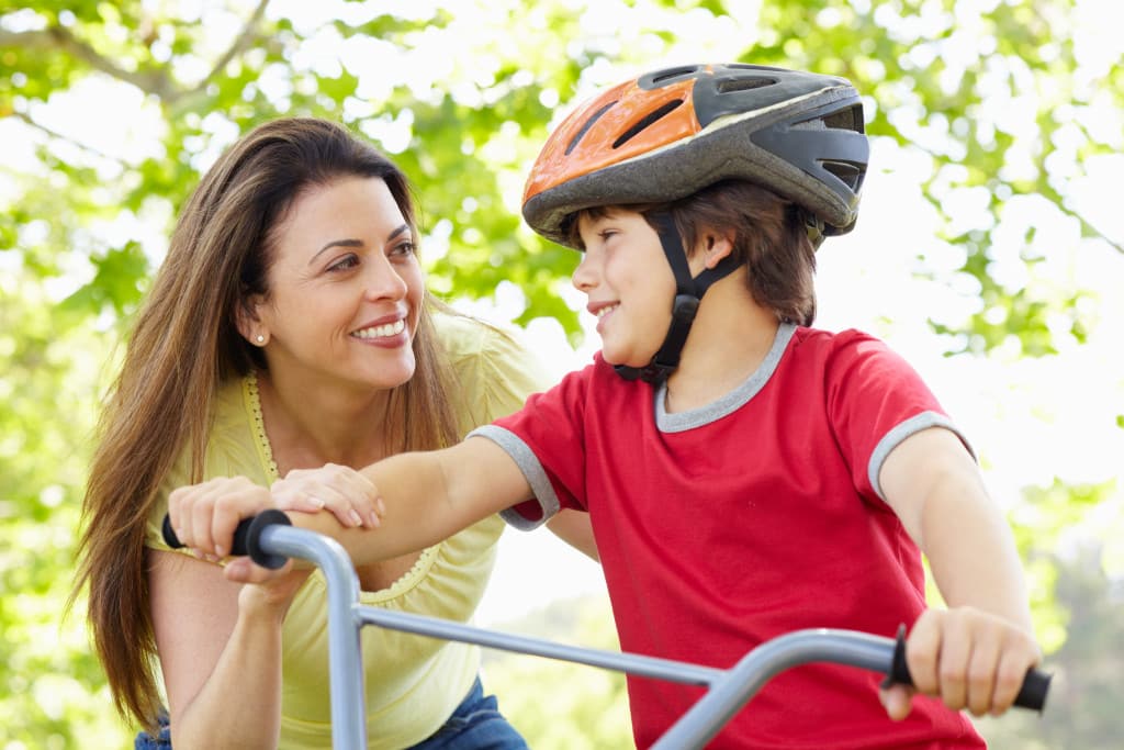 mother teaching son to bike