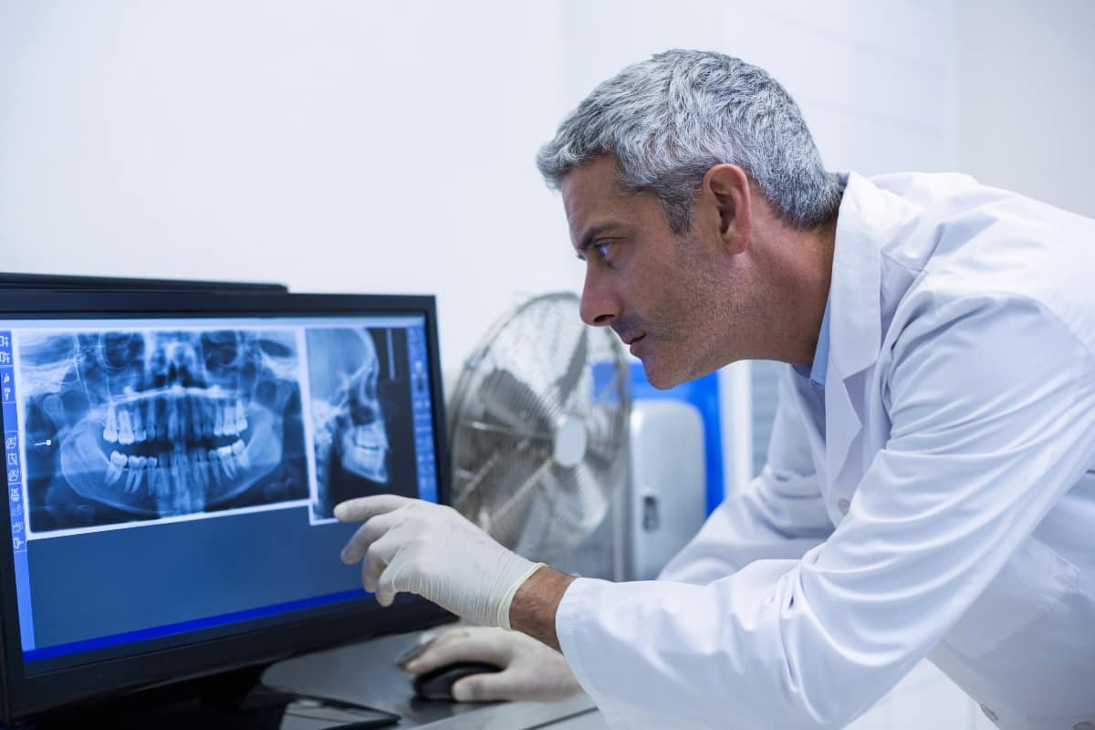dentist examining x-ray results