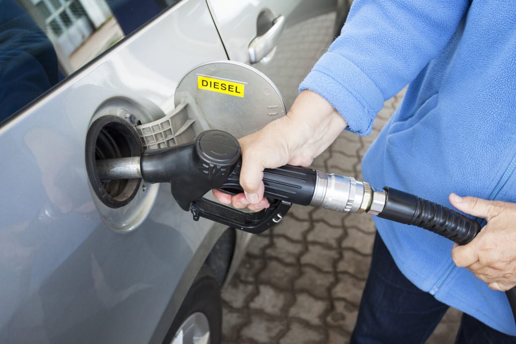 person filling up a car