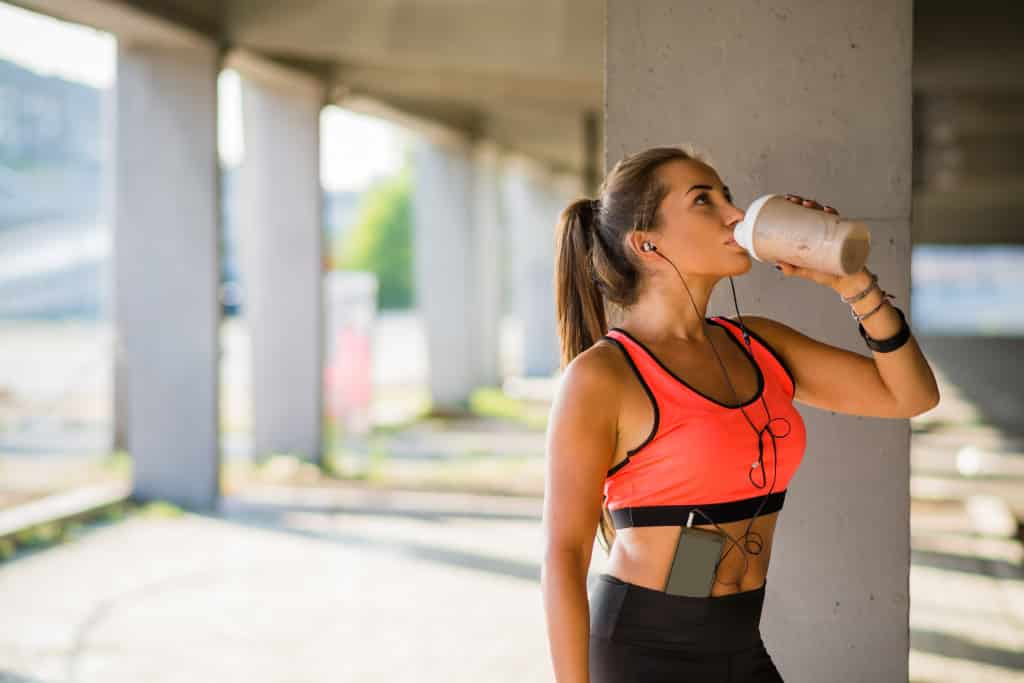 fit woman drinking from her bottle