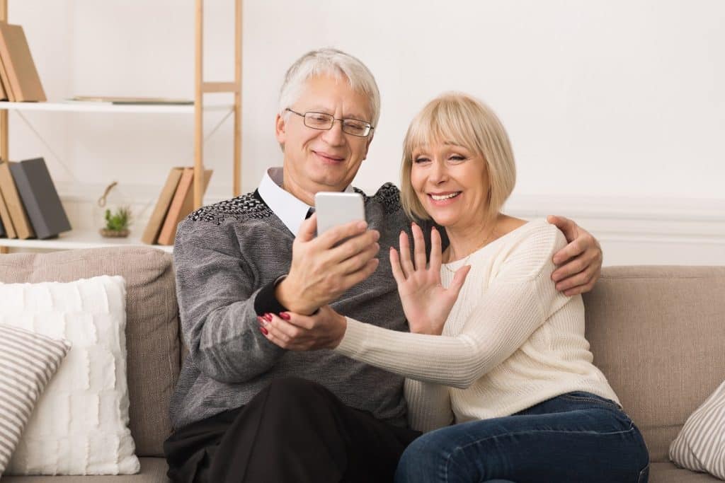 Elderly couple on a video call with family