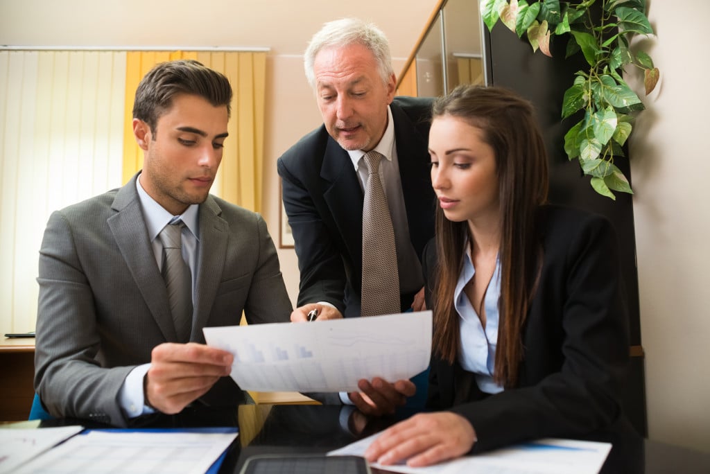 Business professionals working together on a document in an office