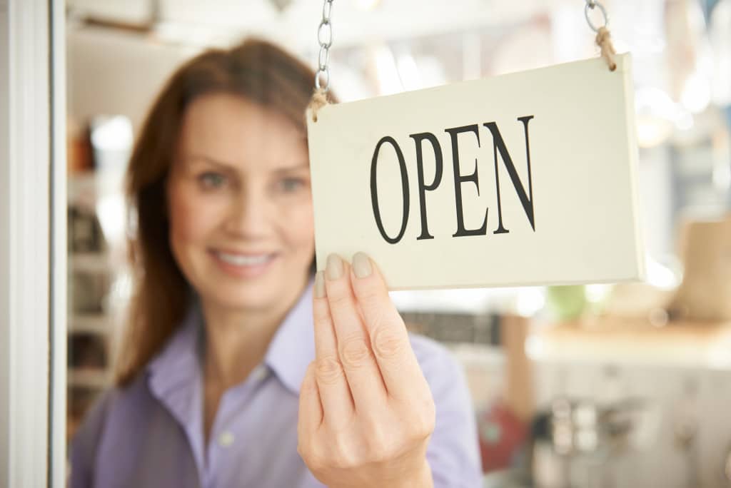 small business owner opening her shop