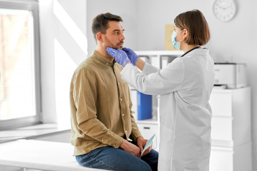 man being checked by a doctor